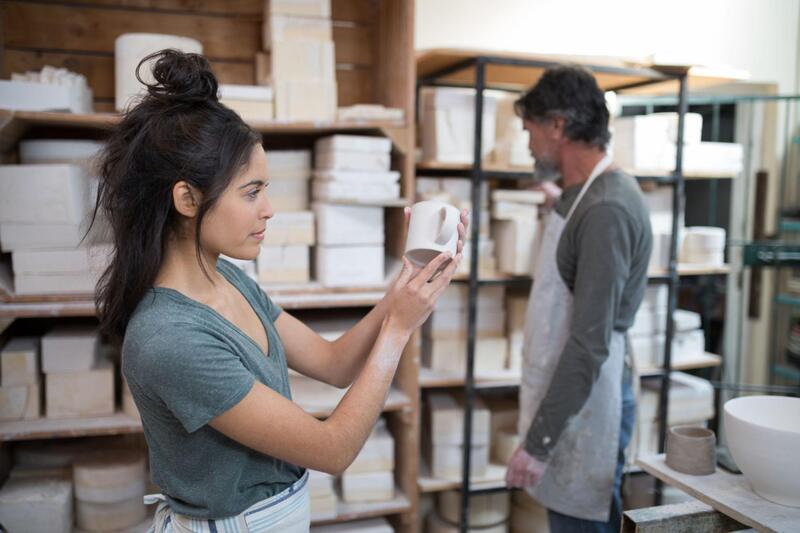 microwave safe ceramic mug A person inspecting the glaze on a ceramic mug for cracks