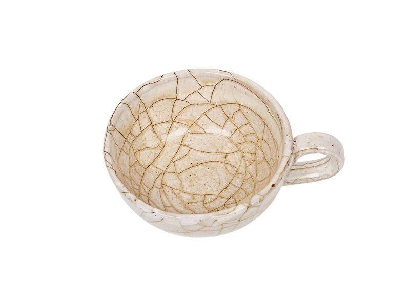 Crazing on a ceramic mug glaze Close-up image showing crazing or fine cracks on a ceramic glaze