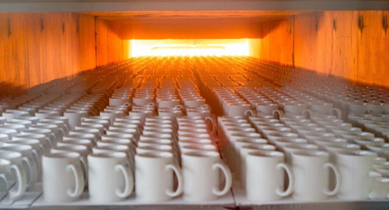 Ceramic Mug Manufacturing Process Ceramic mugs moving through a controlled kiln firing process