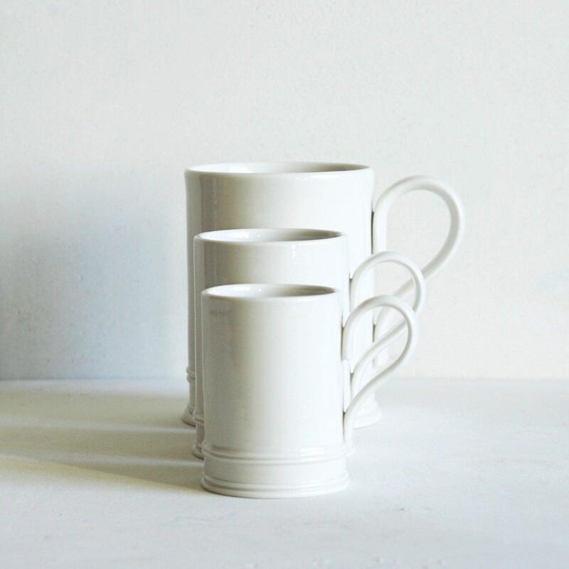 Stack of classic white ceramic mugs Stackable classic white ceramic mugs for wholesale and retail