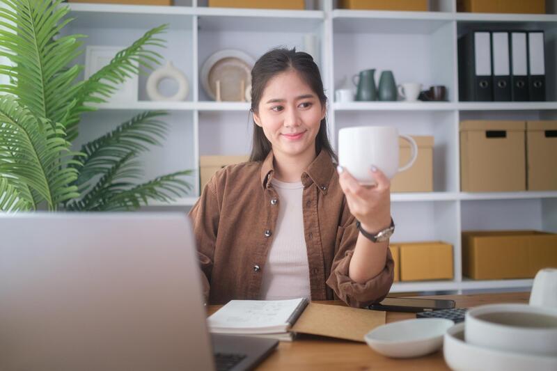 Buyer Asking Questions about Mug Sustainability Buyer reviewing product specifications and certifications with a ceramic mug supplier.
