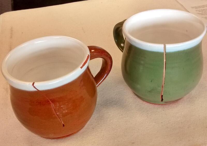 Structural crack extending through the ceramic body of a mug