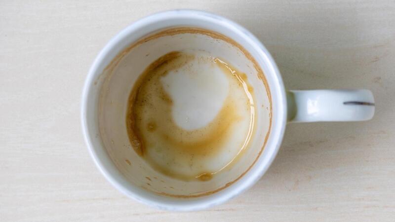 Coffee residue trapped inside cracks of a ceramic mug