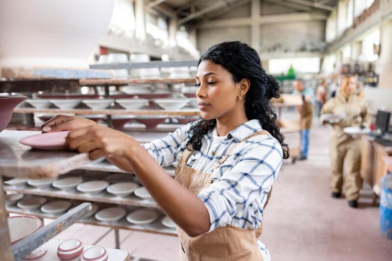 Ceramic Mug Quality Control Quality inspector checking ceramic mugs on a production line.