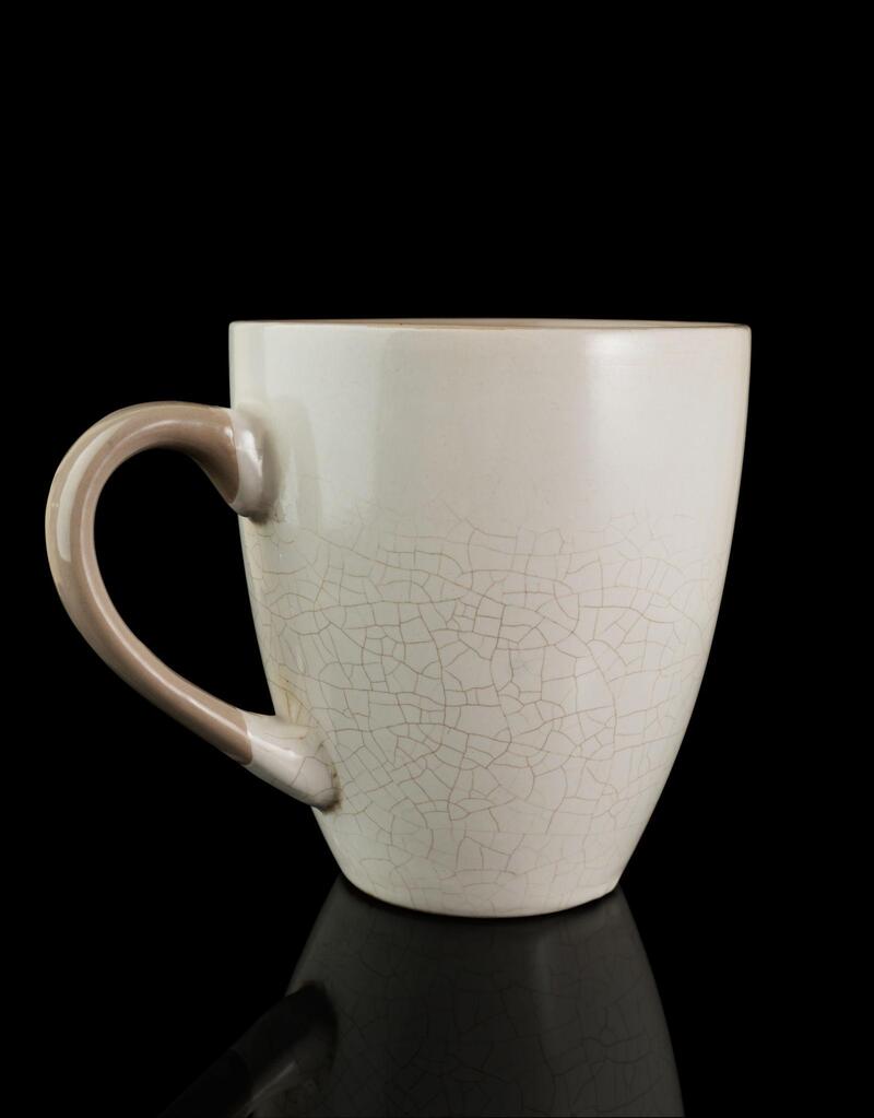 Cracked Glazed Pottery in Microwave A cracked ceramic mug after being in the microwave
