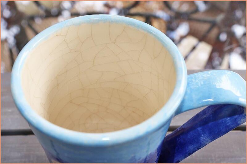 Close-up of glaze crazing showing fine crack patterns on ceramic mug Close-up of crazing on a ceramic glaze