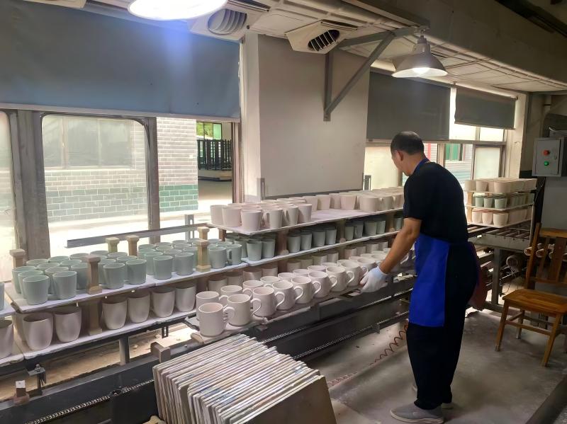 Ceramic Mugs Entering a Kiln Ceramic mugs entering a kiln, a critical step for ensuring lead-safe products.